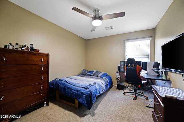 bedroom with light carpet, visible vents, and ceiling fan