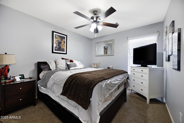 carpeted bedroom with ceiling fan and baseboards