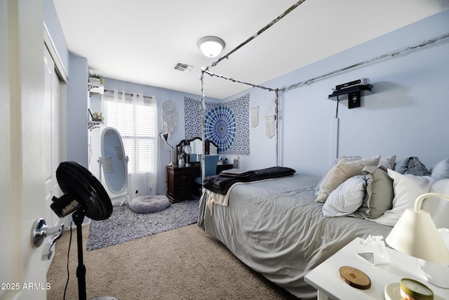 bedroom with visible vents, carpet floors, and a closet