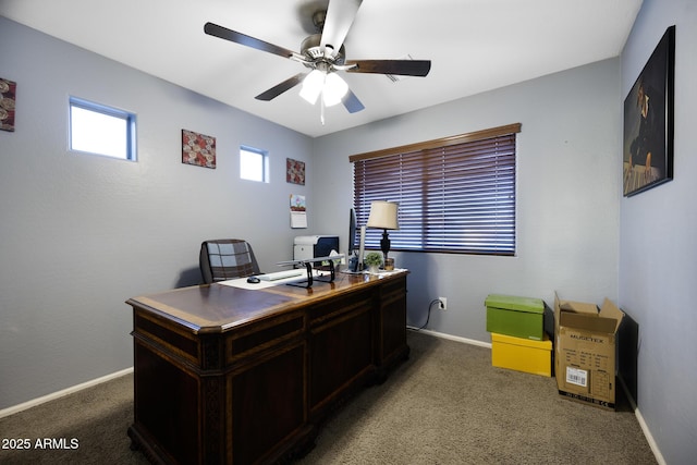 carpeted home office with baseboards and ceiling fan