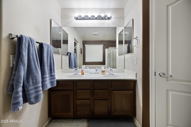 full bath with double vanity, a shower, and a sink