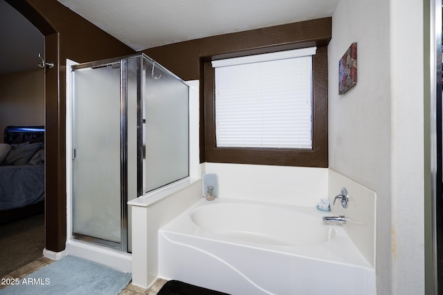 bathroom with ensuite bath, a shower stall, and a bath