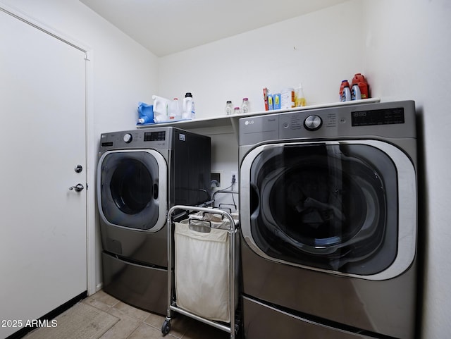 laundry room with light tile patterned flooring, laundry area, and washer and dryer