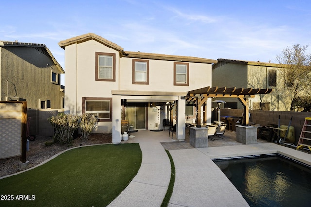 back of property with a fenced backyard, stucco siding, a pergola, and a patio