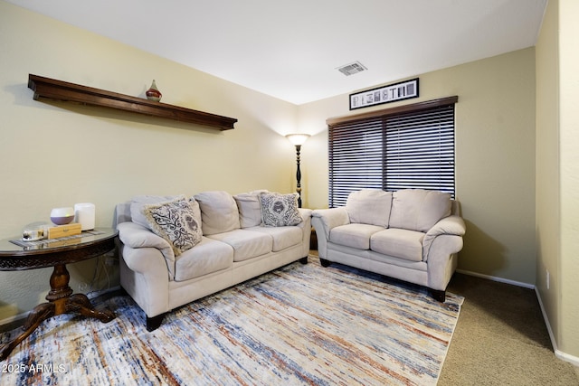living area featuring visible vents, baseboards, and carpet floors