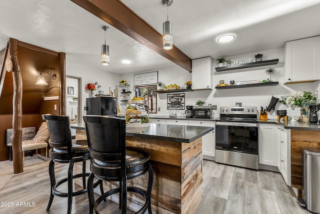 kitchen with electric stove, dark countertops, decorative light fixtures, white cabinetry, and open shelves