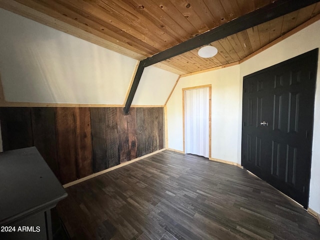 additional living space with wood ceiling, wood walls, vaulted ceiling with beams, and dark hardwood / wood-style flooring