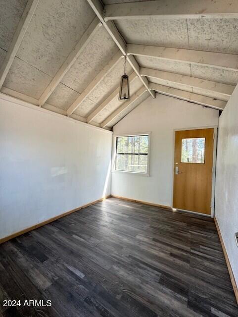 1725 Turkey Mountain Rd, Happy Jack, AZ 86024 - unfurnished room with vaulted ceiling with beams, baseboards, and wood finished floors