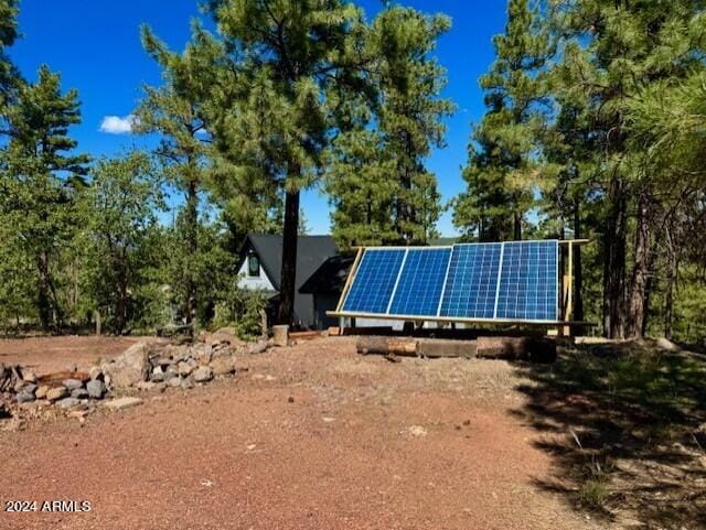 1725 Turkey Mountain Rd, Happy Jack, AZ 86024 - view of side of property featuring ground mounted solar panels