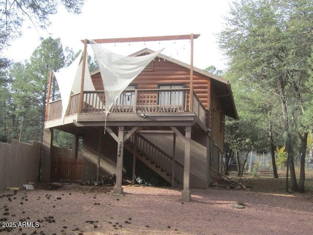 back of house featuring a deck