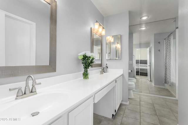 bathroom with a bidet, vanity, a shower, tile patterned floors, and toilet