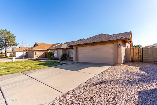 single story home with a garage and a front lawn