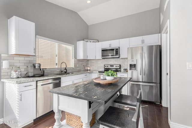 kitchen featuring sink, a center island, white cabinets, and appliances with stainless steel finishes