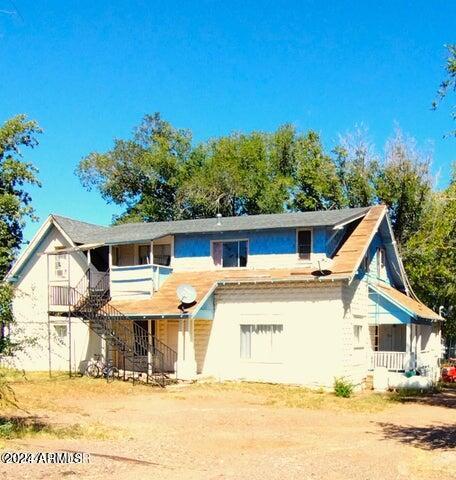 rear view of property featuring a balcony