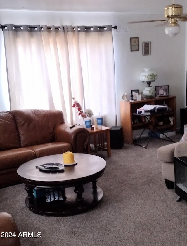 carpeted living room featuring ceiling fan and a healthy amount of sunlight