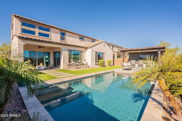 rear view of property featuring a patio area and ceiling fan