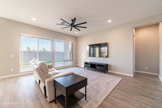 living room with ceiling fan and light hardwood / wood-style floors