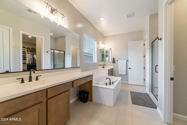 bathroom featuring plus walk in shower, vanity, and tile patterned floors