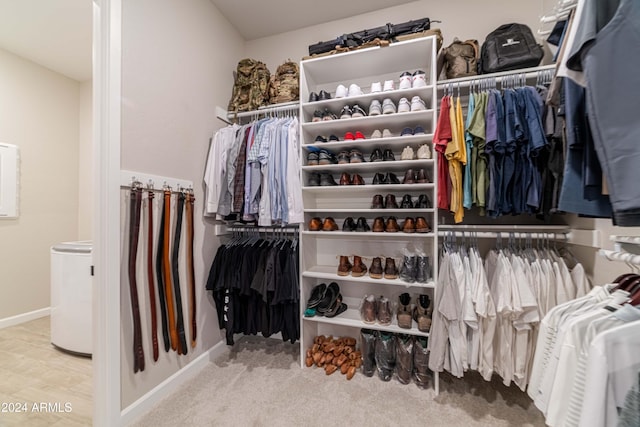 walk in closet with carpet flooring