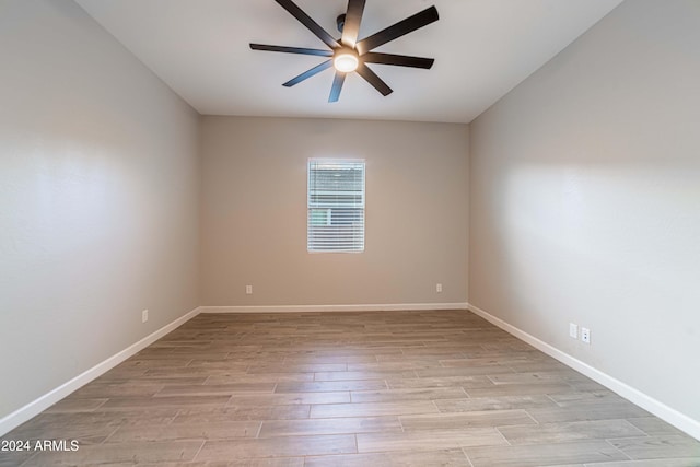 spare room with light hardwood / wood-style floors and ceiling fan