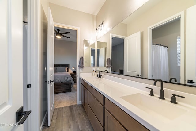 bathroom featuring ceiling fan, vanity, and wood-type flooring