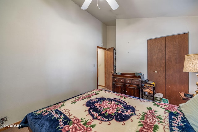 bedroom with ceiling fan, a closet, and vaulted ceiling