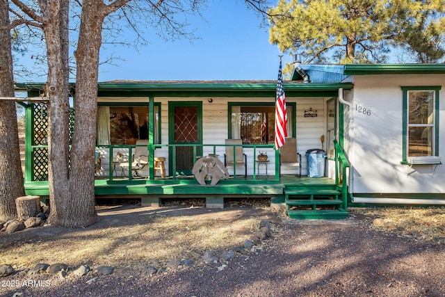 single story home featuring covered porch