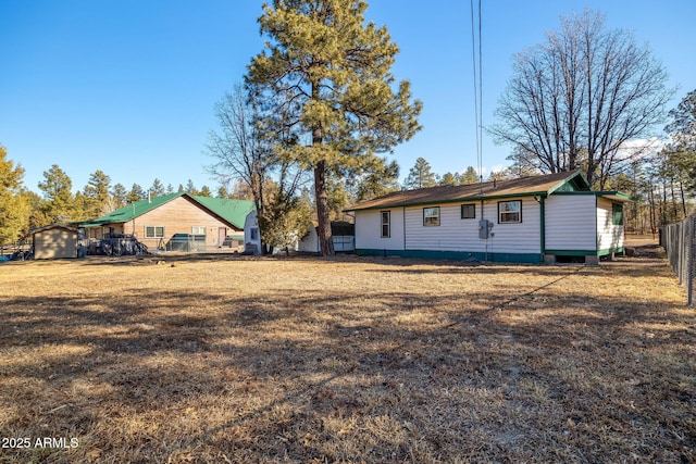 back of house with a lawn