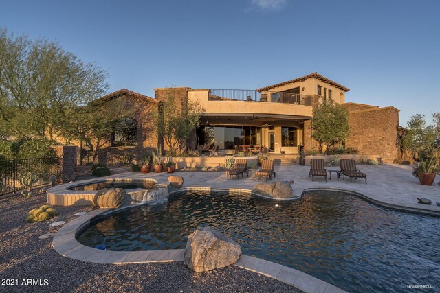 9161 E Superstition Mountain Dr, Gold Canyon, AZ 85118 - back of house with a pool with hot tub, a patio area, and a balcony