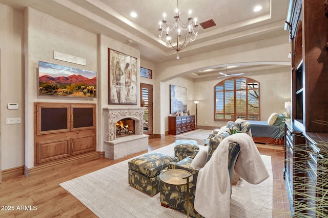 9161 E Superstition Mountain Dr, Gold Canyon, AZ 85118 - living room featuring a notable chandelier, light hardwood / wood-style floors, and a raised ceiling