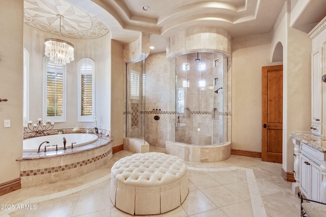 9161 E Superstition Mountain Dr, Gold Canyon, AZ 85118 - bathroom with tile patterned floors, independent shower and bath, a raised ceiling, vanity, and a chandelier