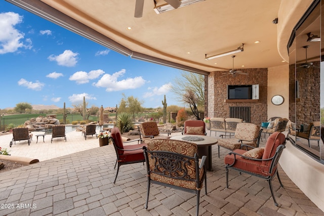 9161 E Superstition Mountain Dr, Gold Canyon, AZ 85118 - view of patio / terrace featuring ceiling fan and an outdoor living space with a fireplace