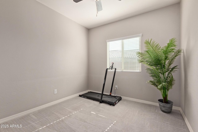 exercise room featuring ceiling fan and light colored carpet