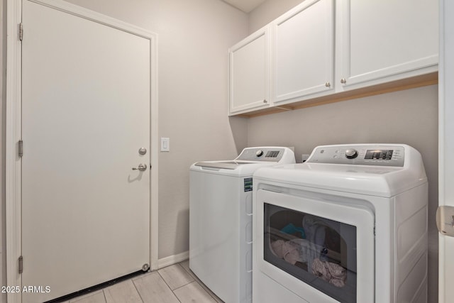 laundry area featuring cabinets and washing machine and clothes dryer