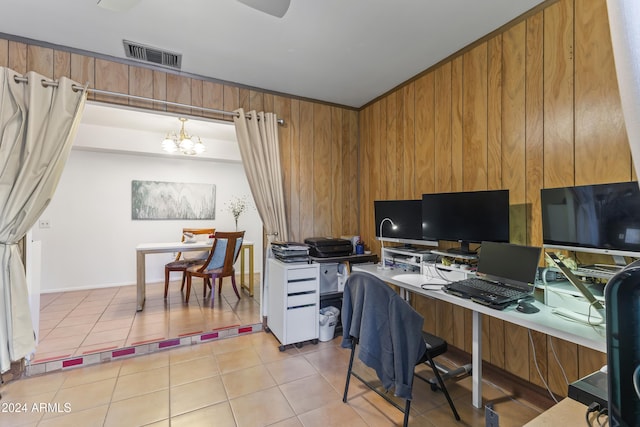 office space featuring a chandelier, wooden walls, and light tile patterned flooring