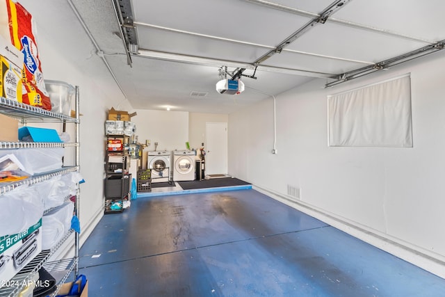 garage with separate washer and dryer and a garage door opener