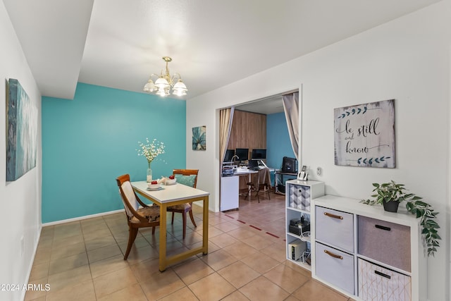 dining space with light tile patterned floors and an inviting chandelier