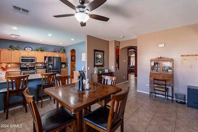 tiled dining room with ceiling fan