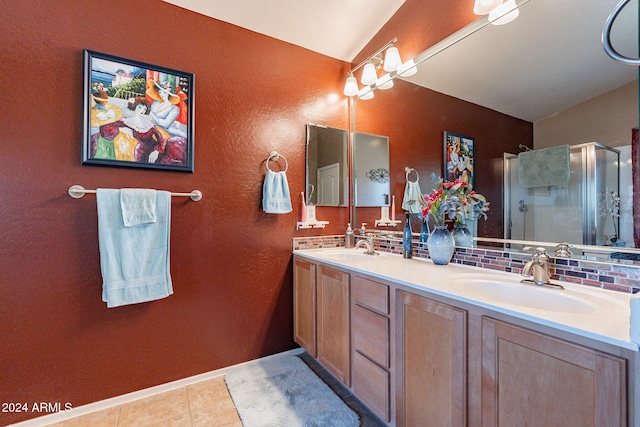 bathroom featuring tile patterned floors, vanity, walk in shower, and tasteful backsplash