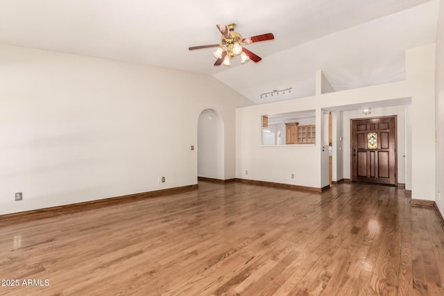 16216 N Runyon Pl, Fountain Hills, AZ 85268 - unfurnished living room with vaulted ceiling, a ceiling fan, wood finished floors, arched walkways, and baseboards