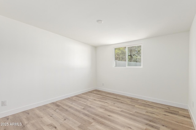 unfurnished room with light wood-type flooring