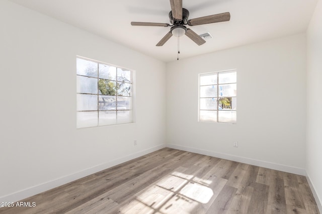 spare room featuring ceiling fan and light hardwood / wood-style floors