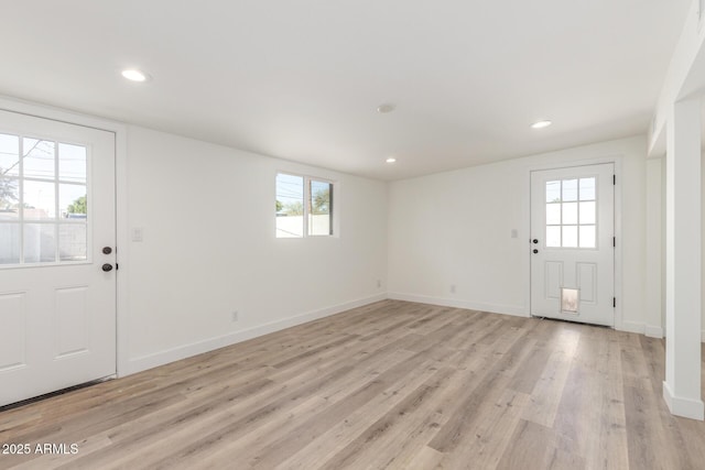 foyer entrance with light wood-type flooring