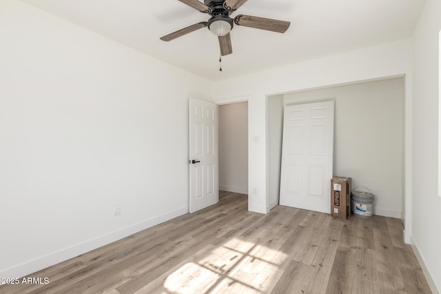 unfurnished bedroom with ceiling fan, light hardwood / wood-style floors, and a closet