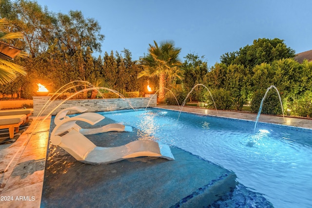 view of pool featuring pool water feature and a hot tub