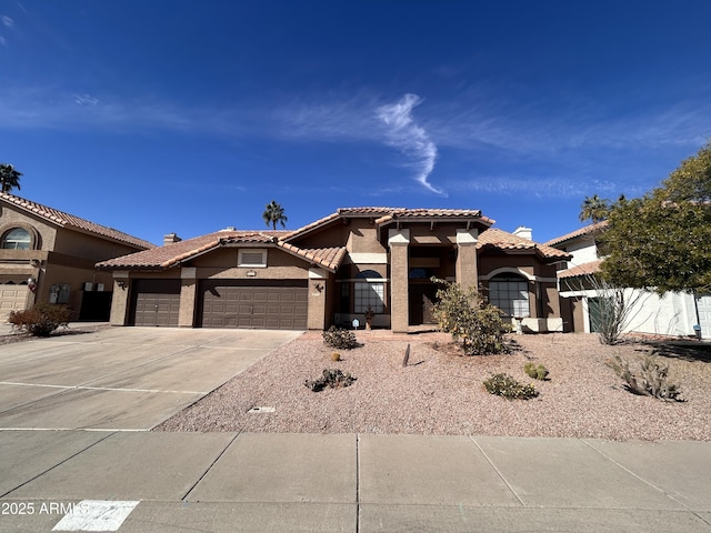 mediterranean / spanish-style home with a garage