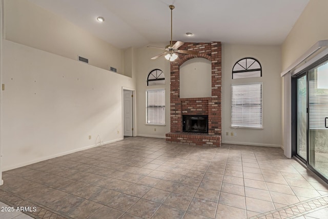 unfurnished living room with light tile patterned flooring, high vaulted ceiling, ceiling fan, and a fireplace