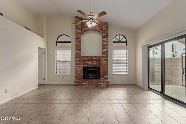 unfurnished living room with a fireplace, high vaulted ceiling, ceiling fan, and light tile patterned floors