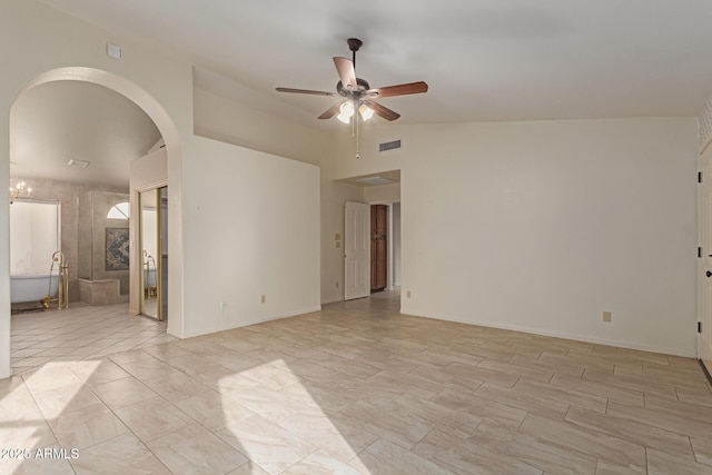 empty room featuring ceiling fan and lofted ceiling