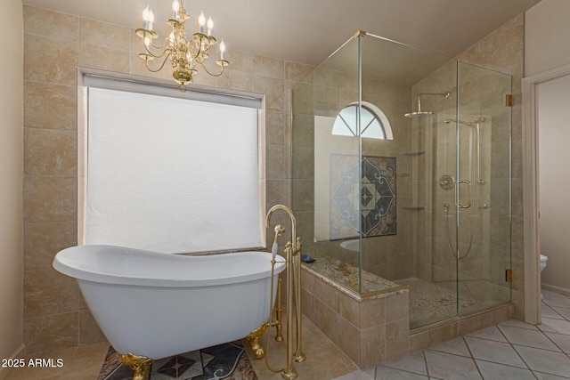 bathroom with tile patterned flooring, an inviting chandelier, and independent shower and bath